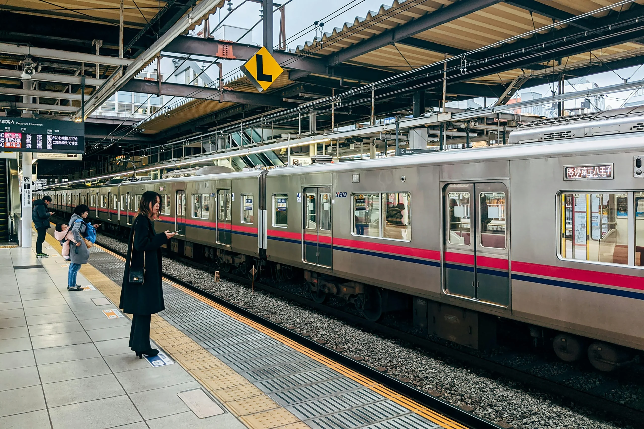 Tokyo-public-transport-scene-for-a-Tokyo-travel-guide-showing-travelers-at-a-station-scaled What First-Time Visitors Should Know About Tokyo Before They Go