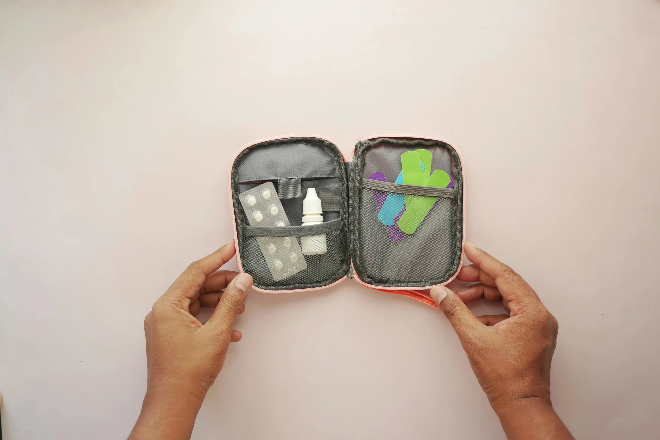 backup travel safety habits with a pouch holding medicine charger passport holder and emergency contacts