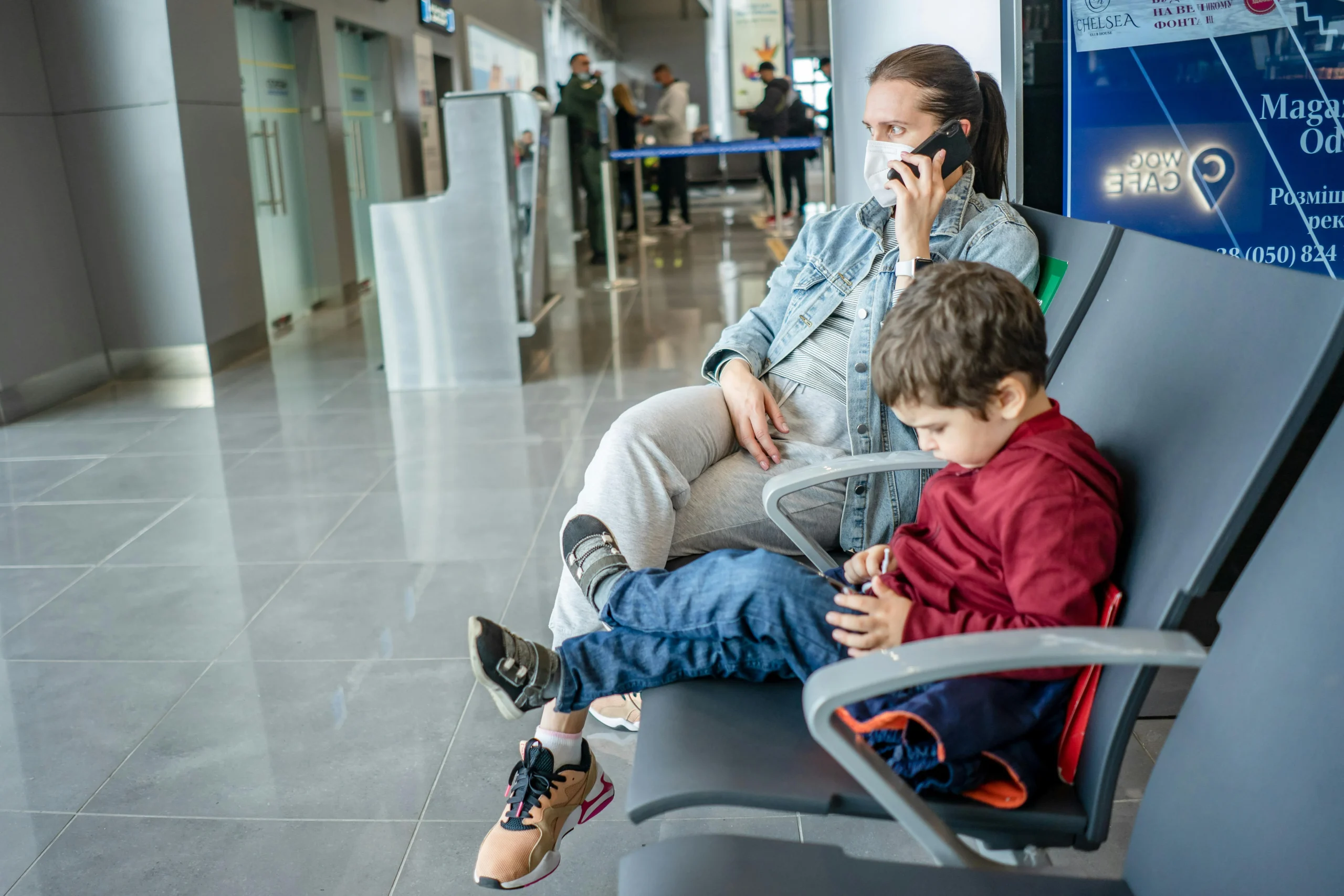 family trip planning habits with a parent reviewing arrival details and child luggage before departure
