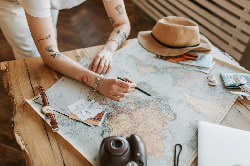 solo travel habits with a traveler calmly reviewing plans at a café table