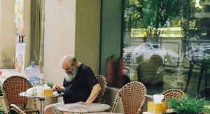 Independent traveler enjoying a meal alone at a café table