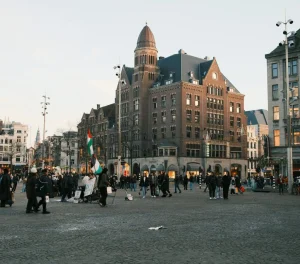 People moving calmly through a crowded public square abroad