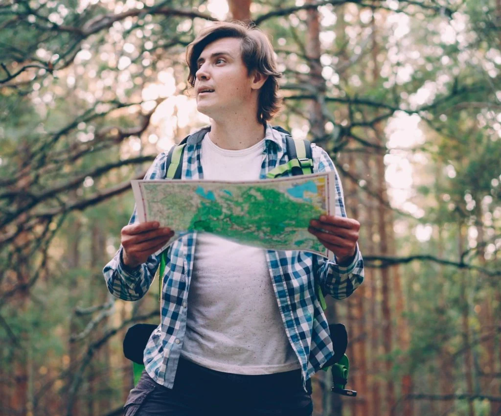 Hiker planning day hike with map and notes