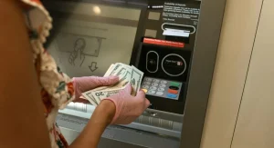traveler using ATM in well-lit area