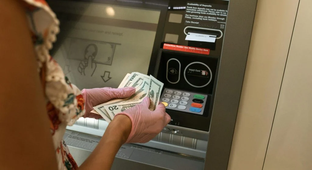 traveler using ATM in well-lit area