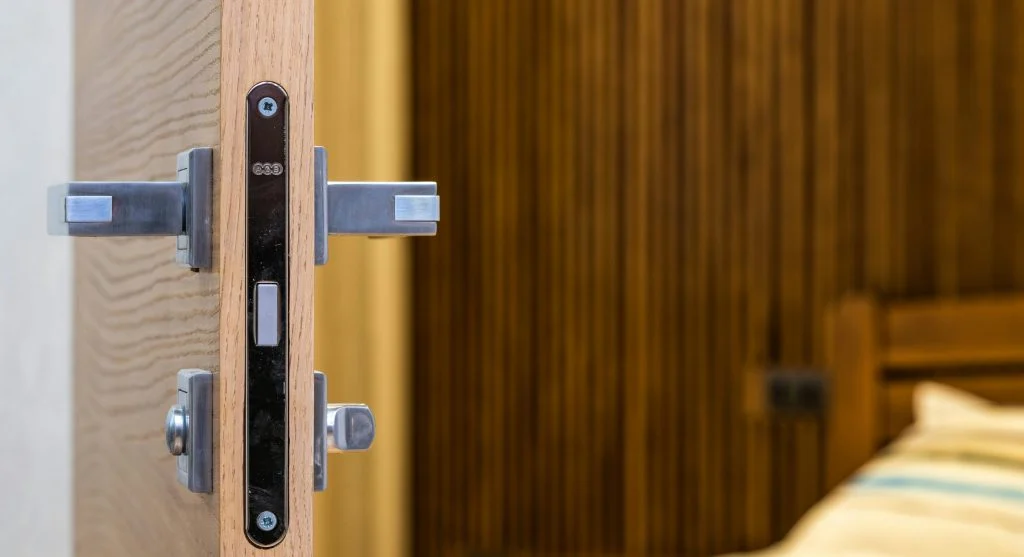 Traveler checking into a hotel room and securing the door