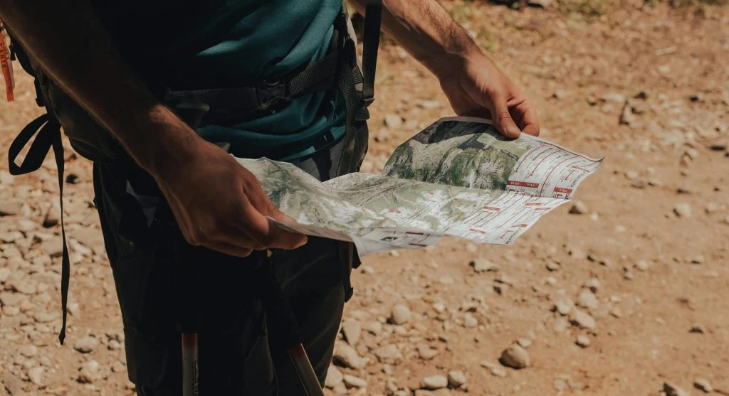 hiker checks time water route