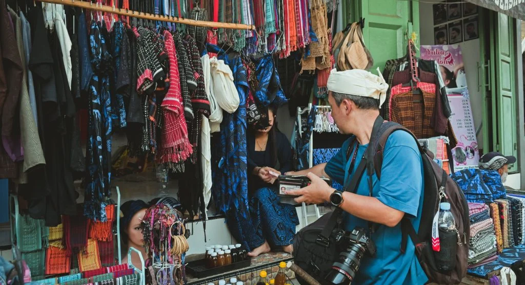 Market manners showing a traveler browsing respectfully in a local market