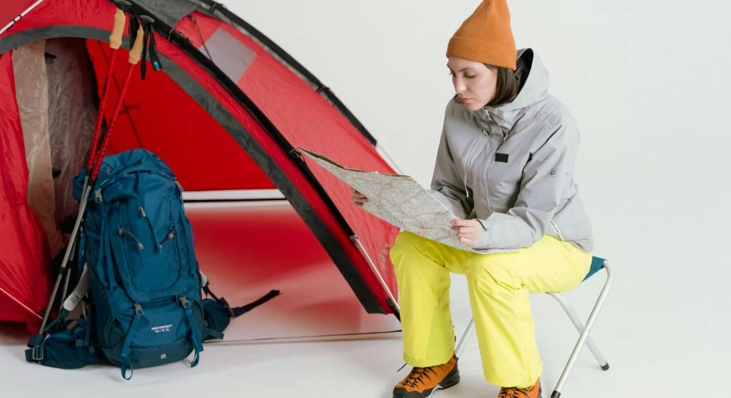 hiker checking map backpack weather