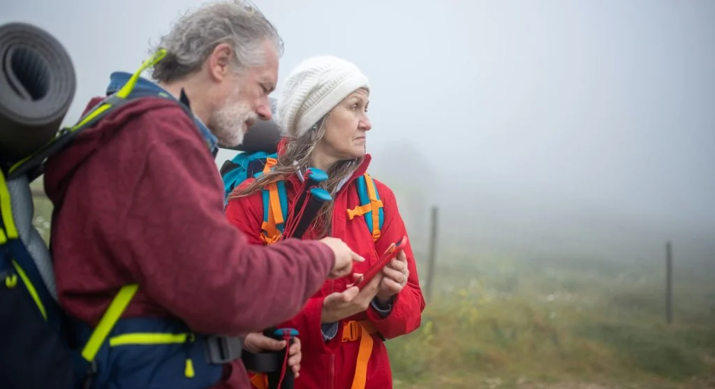hiker checking map backpack weather